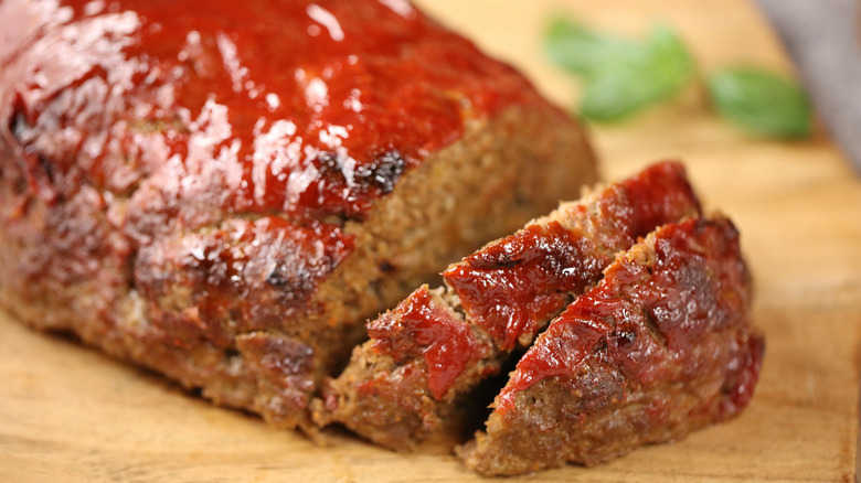 homemade meatloaf sliced on a cutting board