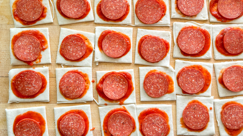 pepperoni slices on dough squares