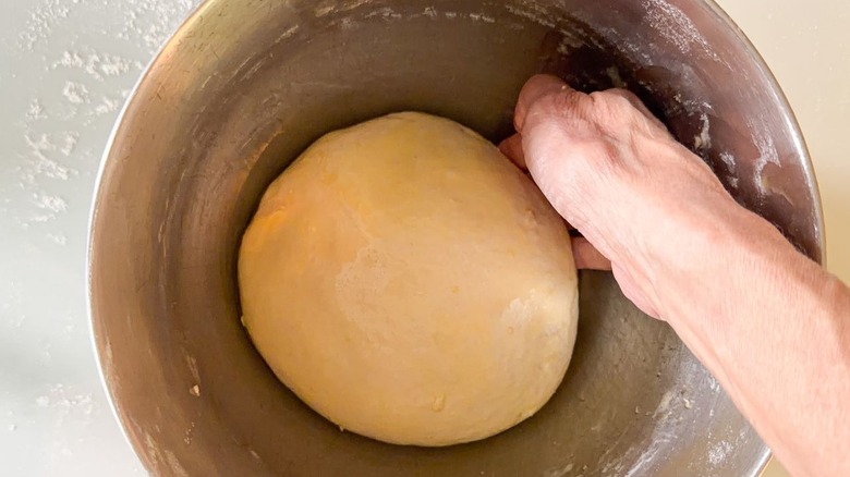 Oiled focaccia dough in mixer bowl