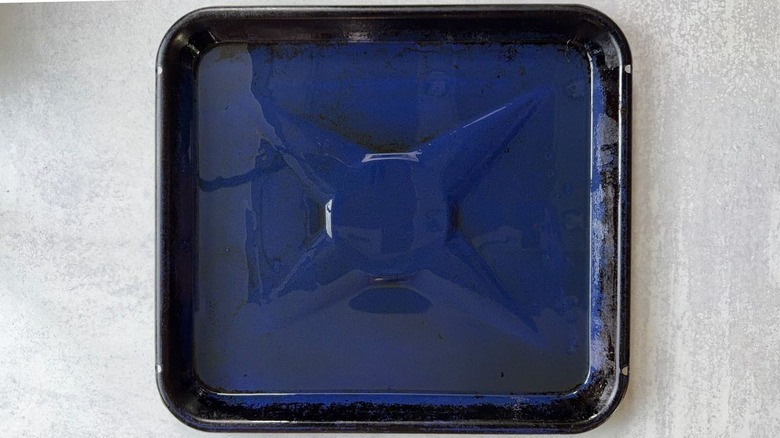 Oiled blue baking sheet on countertop