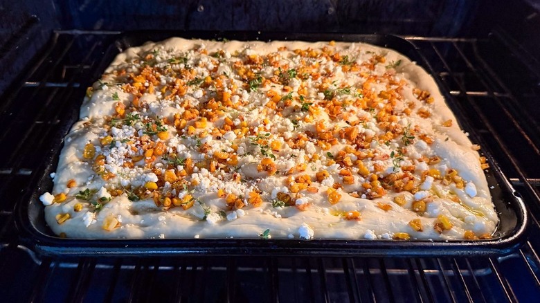 Summer corn and roasted garlic focaccia baking in oven