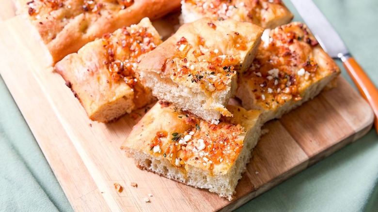 Summer corn and roasted garlic focaccia slices on cutting board