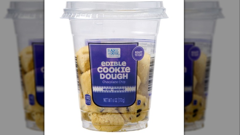 A container showing pieces of edible cookie dough inside of it