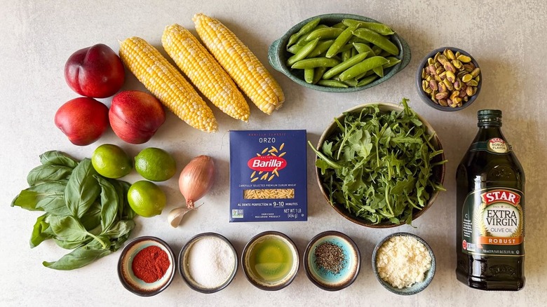 Summery grilled corn and orzo salad ingredients on countertop
