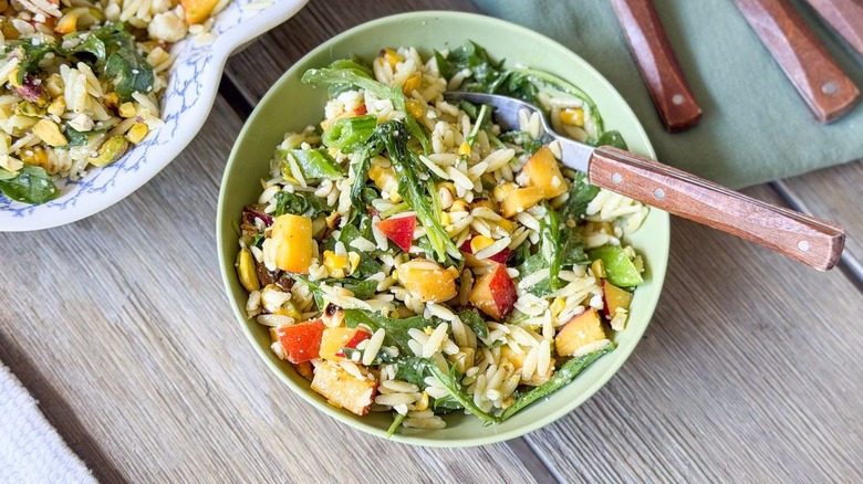 Summery grilled corn and orzo salad in bowl with fork