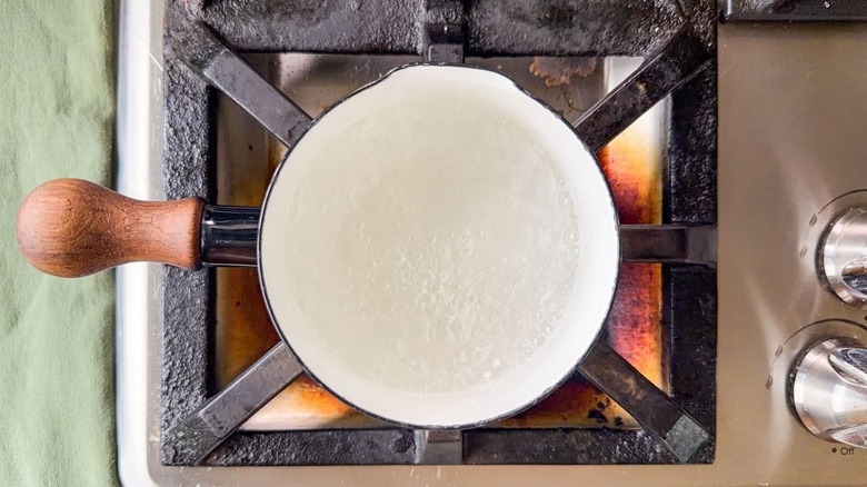 Water, vinegar and sugar simmering in small saucepan on stovetop