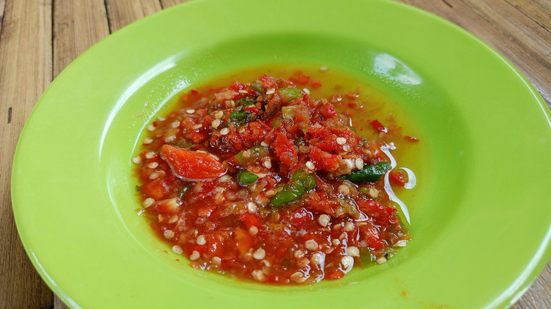 Freshly ground sambal oelek in a green bowl