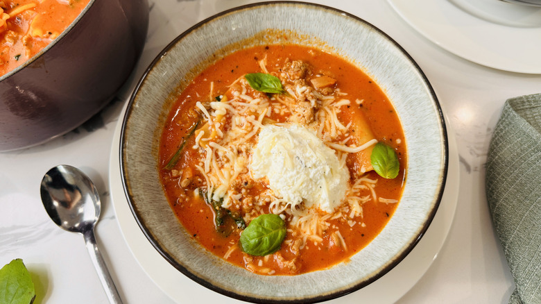 bowl of tomato-noodle soup with cheese