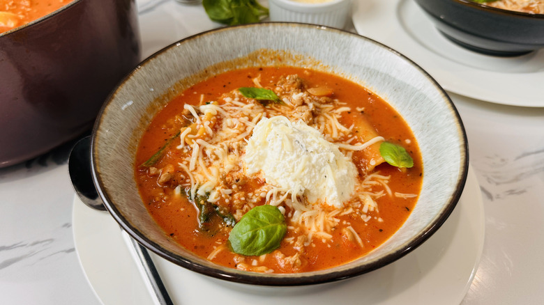 bowl of tomato-noodle soup with cheese