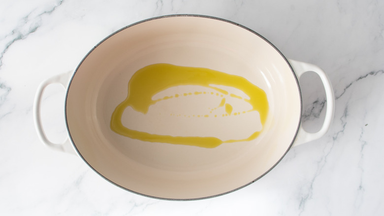 Olive oil drizzle in a Dutch oven