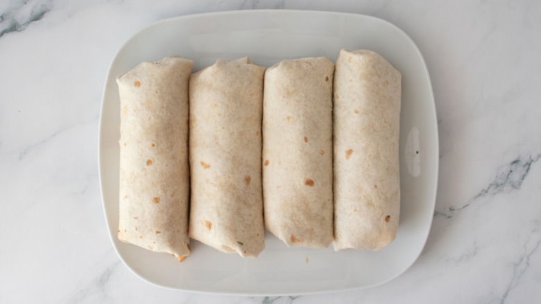 Rolled burritos on plate