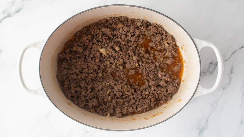Chili-seasoned ground beef in a Dutch oven