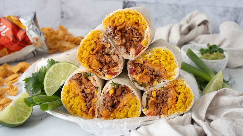 Plated and halved Super-stuffed Frito pie burritos
