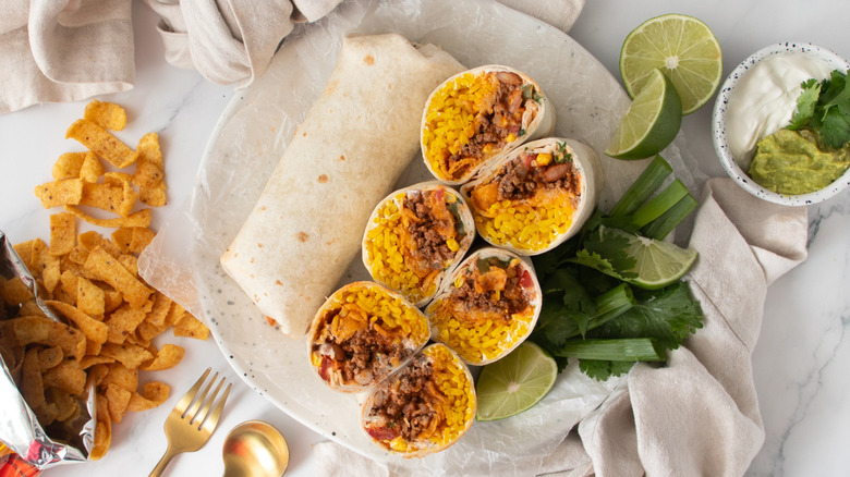 Overhead shot of rolled and plated burritos