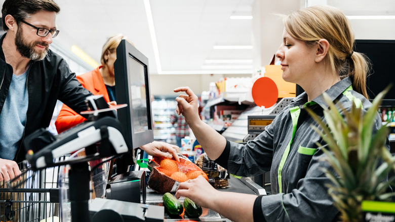 Cashier checking out a customer