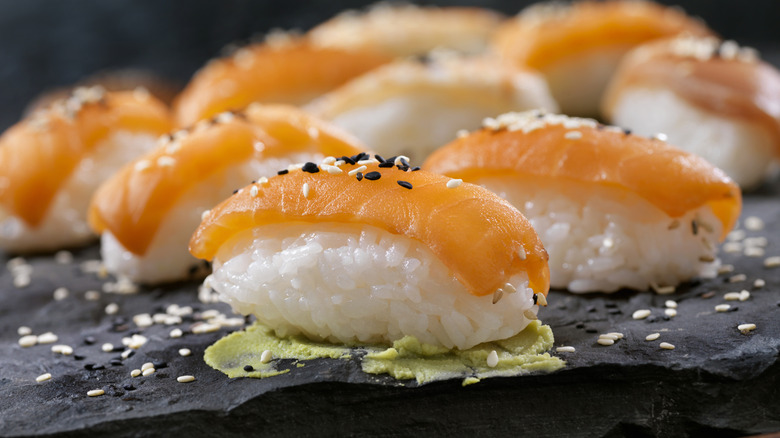 Pieces of salmon sushi with sesame seeds