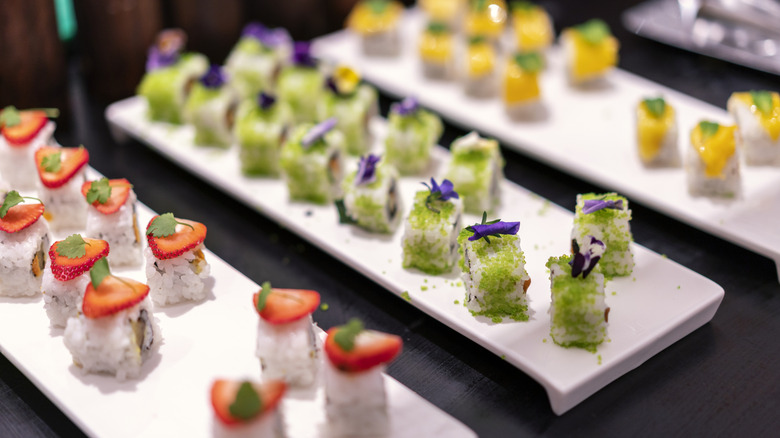Array of sushi rolls on buffet plates