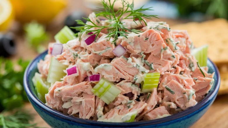 A blue bowl of tuna salad is shown in close-up.