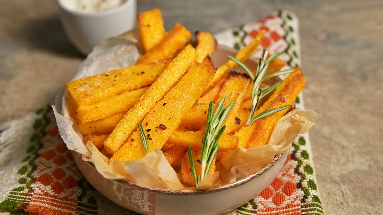 Homemade polenta fries with thyme, rosemary, and yogurt sauce