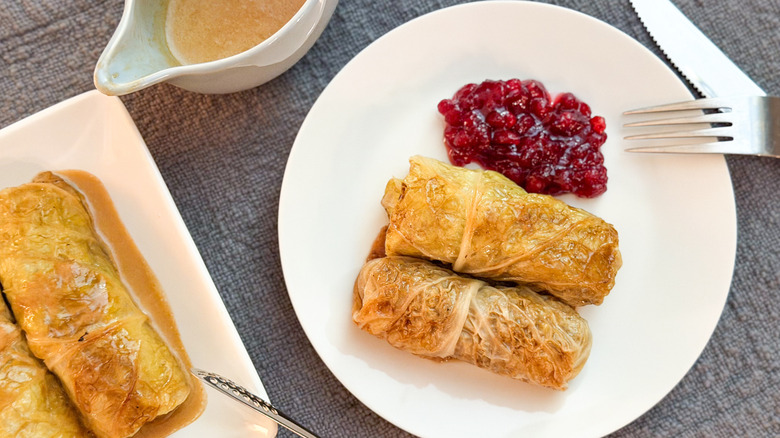 Swedish-inspired stuffed cabbage rolls on serving plate with lingonberries