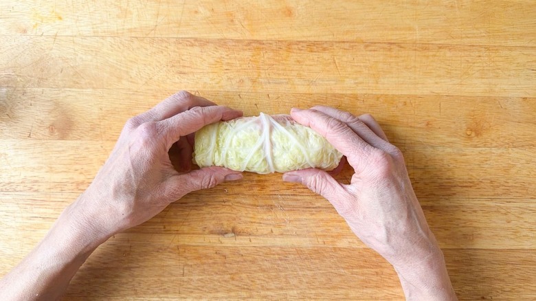Raw Swedish-inspired stuffed cabbage roll on cutting board