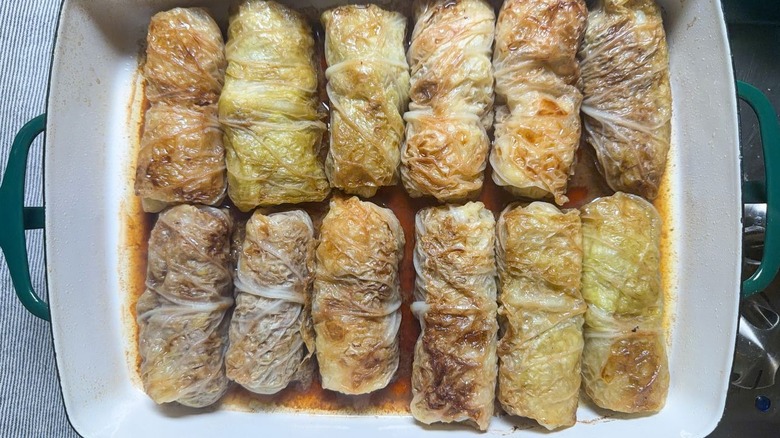 Baked Swedish-inspired stuffed cabbage rolls in baking dish on stovetop