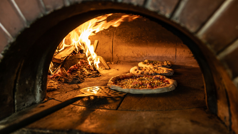 Pizzas in a traditional wood oven
