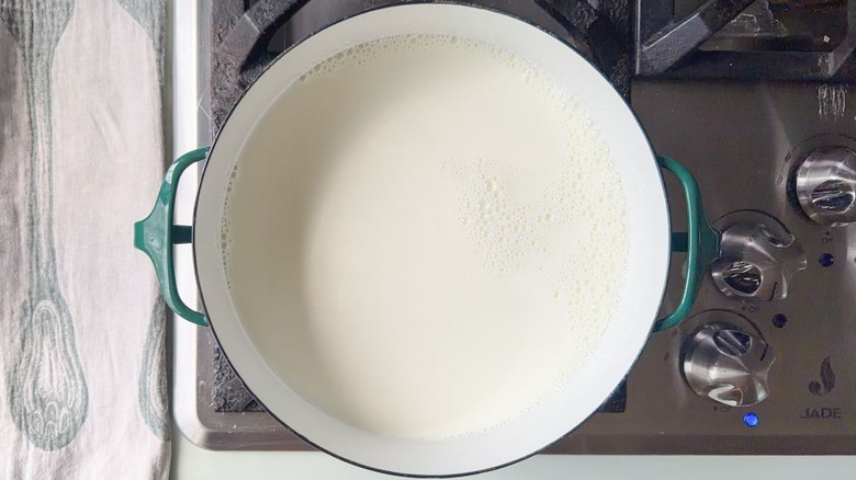 Large saucepan filled with milk on stovetop
