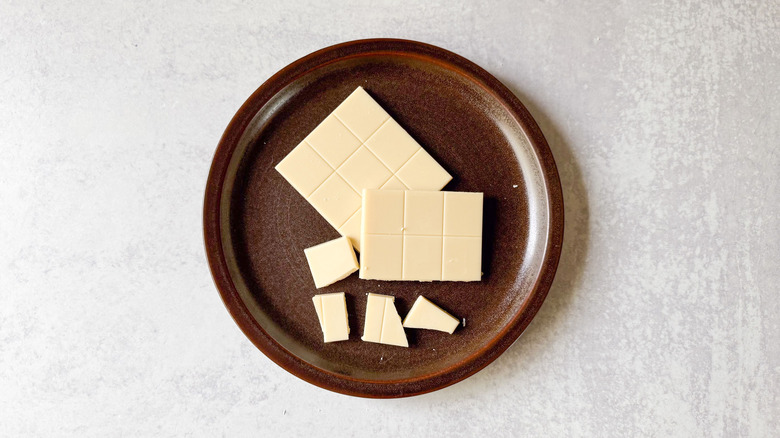 White chocolate bar on brown plate