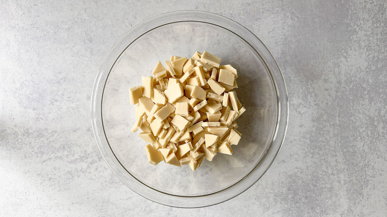 Chopped white chocolate in glass bowl