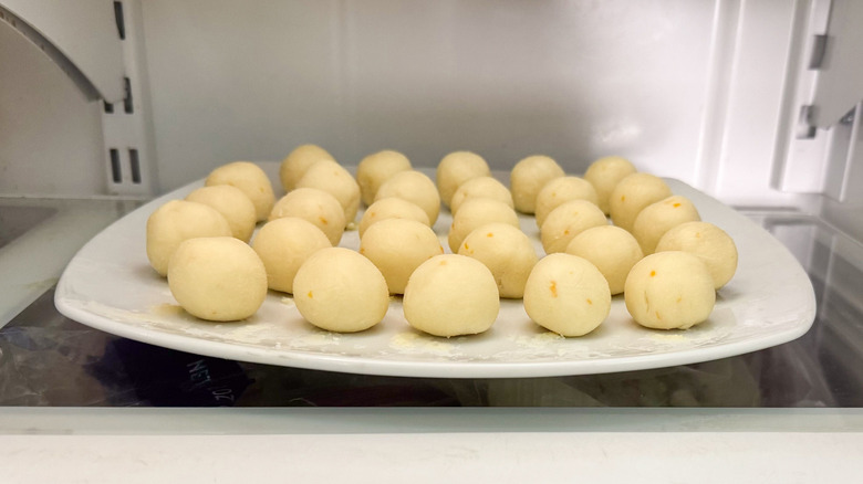 White chocolate meyer lemon truffles on plate in refrigerator