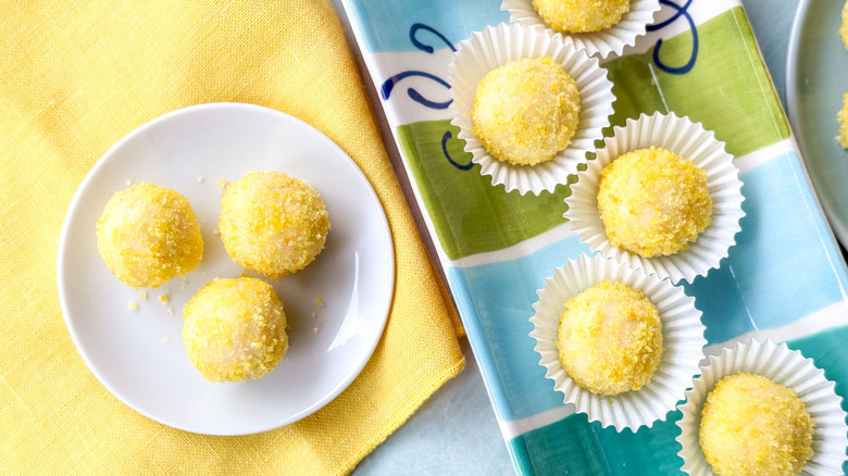 Sweet and simple lemon truffles on serving platter in paper casings