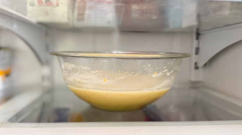 White chocolate and meyer lemon ganache chilling in glass bowl in refrigerator