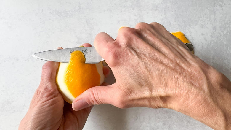 Removing outer zest from Meyer lemon with paring knife