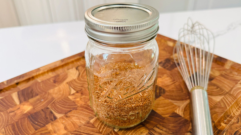Dry rub in mason jar next to whisk