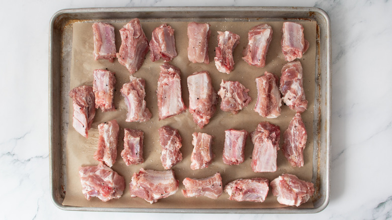 seasoned riblets on a baking sheet