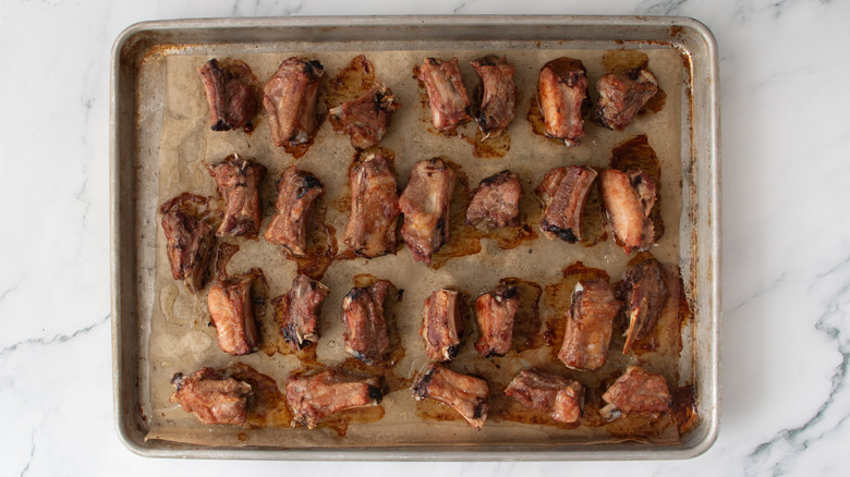 baked riblets on baking sheet