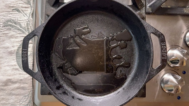 Cast iron skillet with oil on stovetop