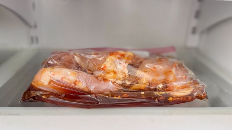 Chicken thighs and honey lime habanero marinade in ziplock bag in refrigerator