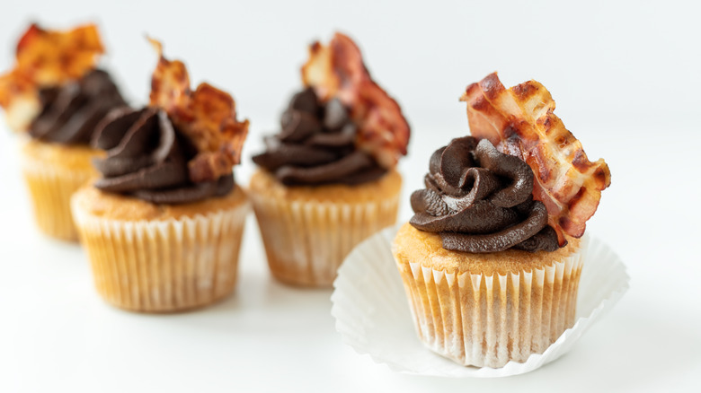 cupcakes with chocolate frosting, garnished with bacon