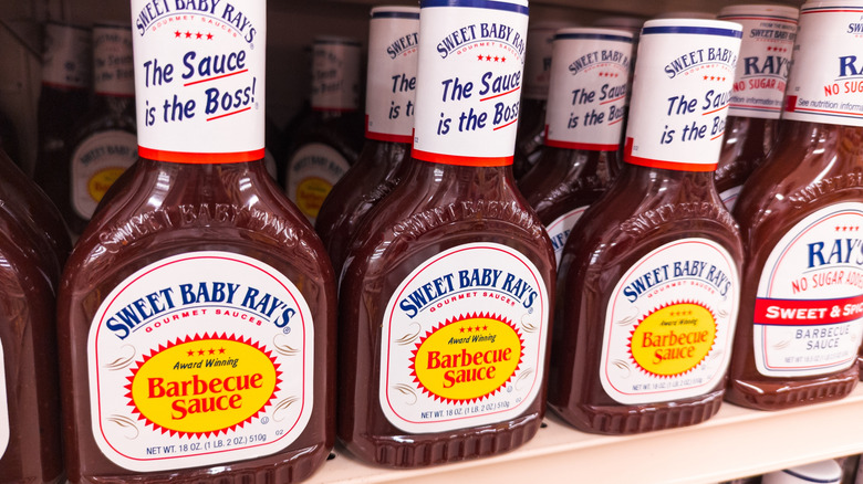 Bottles of Sweet Baby Ray's Barbecue sauce on shelf at the grocery store.