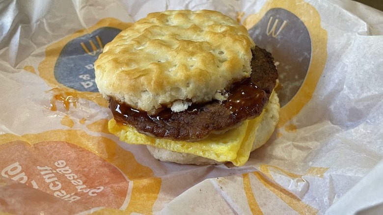 A Hot Honey Sausage Egg Biscuit in its wrapper.