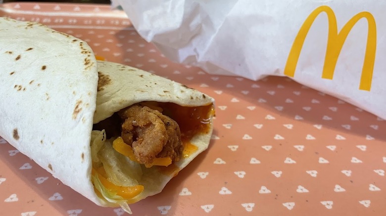 A Hot Honey Snack Wrap next to its packaging.