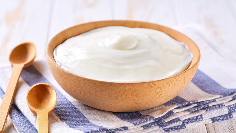 Greek yogurt in wooden bowl
