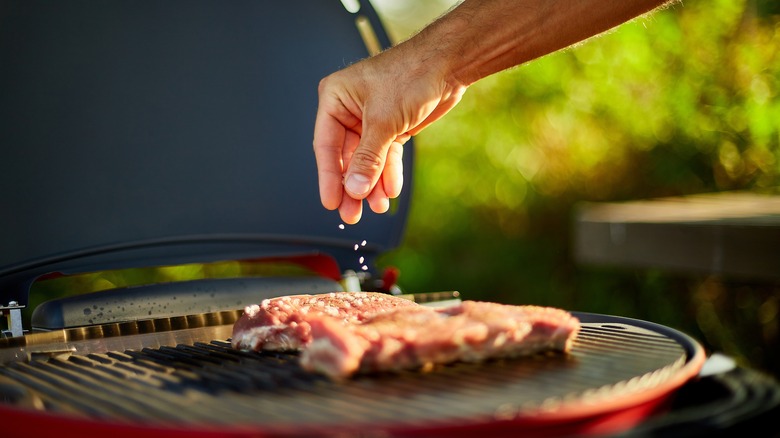 salting steaks on the grill