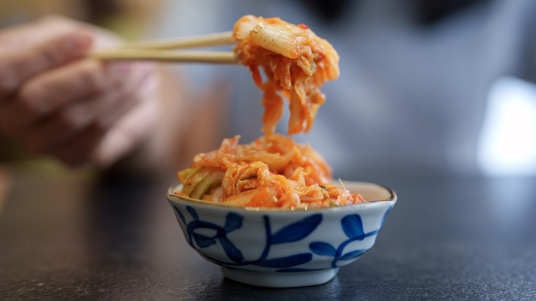 Bowl of kimchi with chopsticks