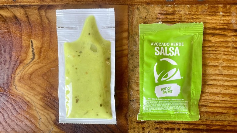 Two packets of Taco Bell Avocado Verde Salsa lying on opposite sides