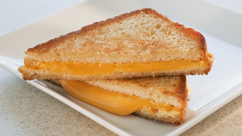 Two halves of a grilled cheese sandwich stacked