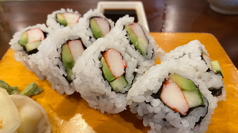 California sushi roll sliced on a yellow plate