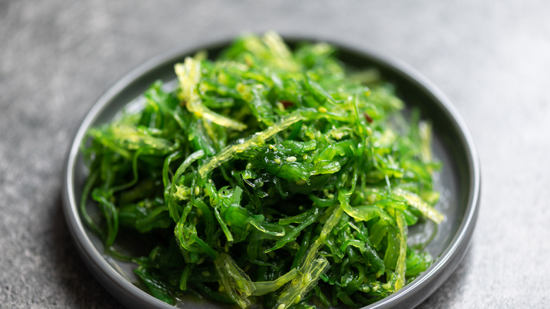 seaweed wakame salad on a black plate